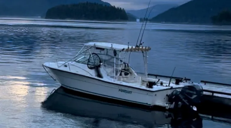 Pursuit 2655 fishing boat tied to dock